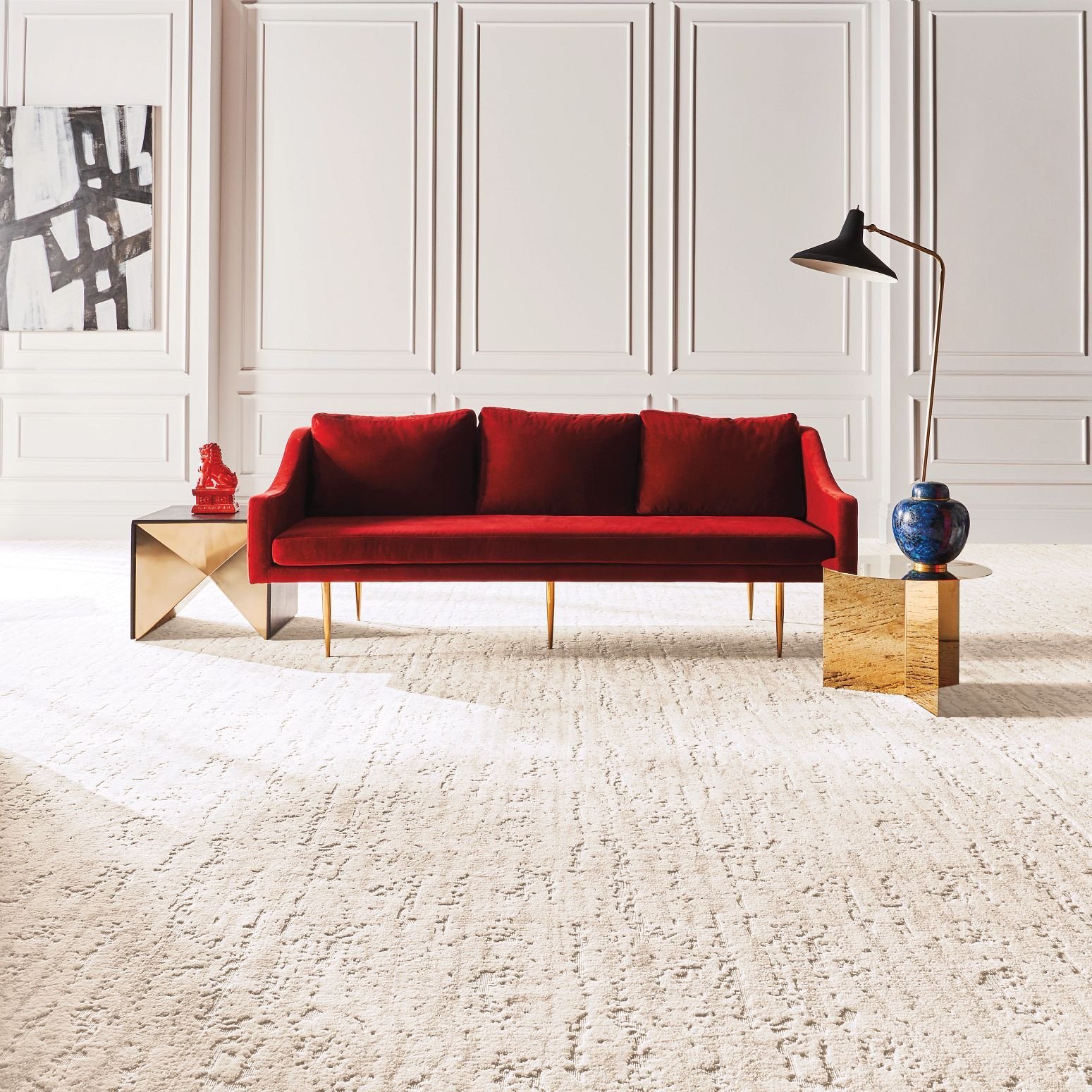 Bright living room with a red velvet couch and beige textured carpet from Carpet On Wheels in the Jamesburg, NJ area